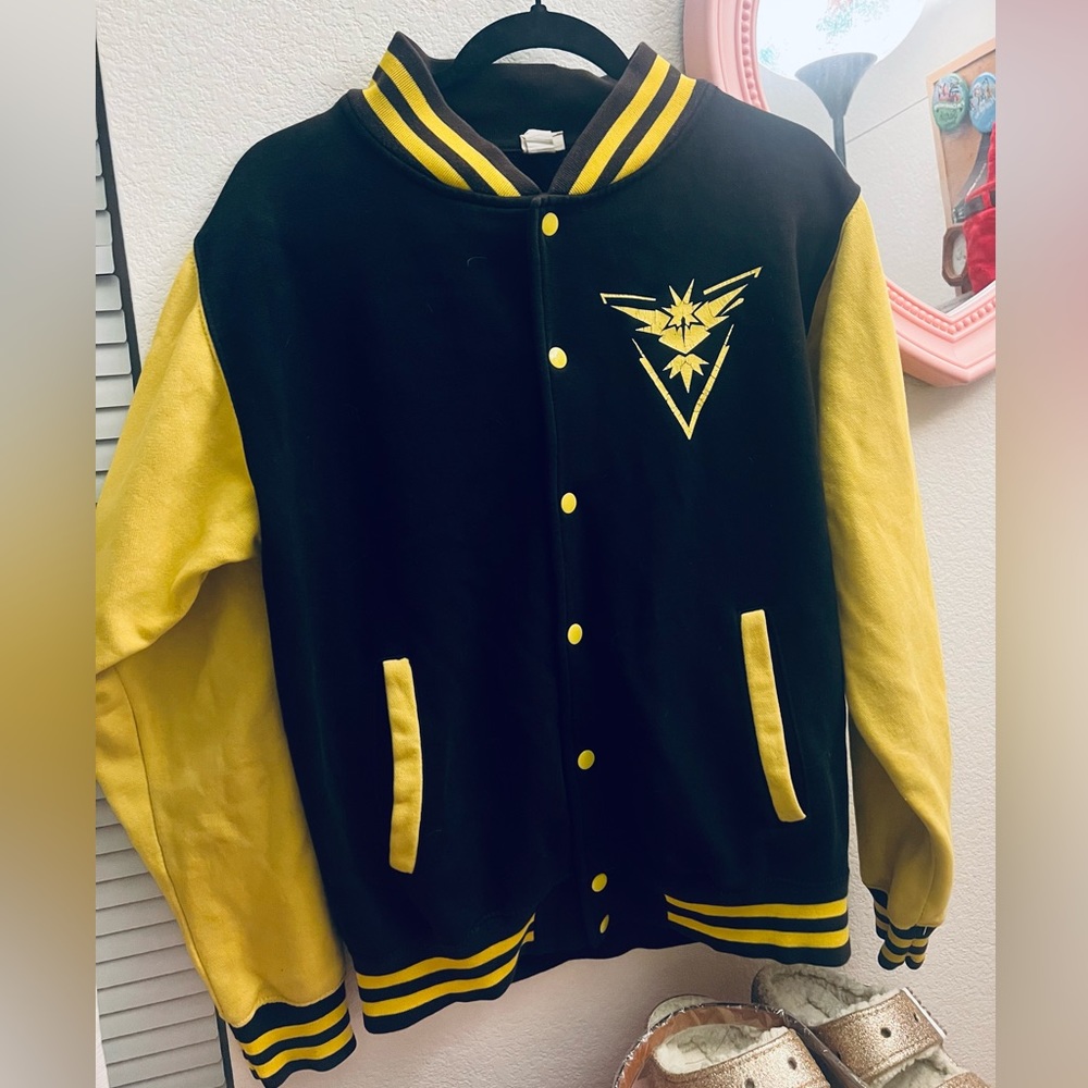 cute lil varsity jacket, black and yellow. apparently a pokemon logo?